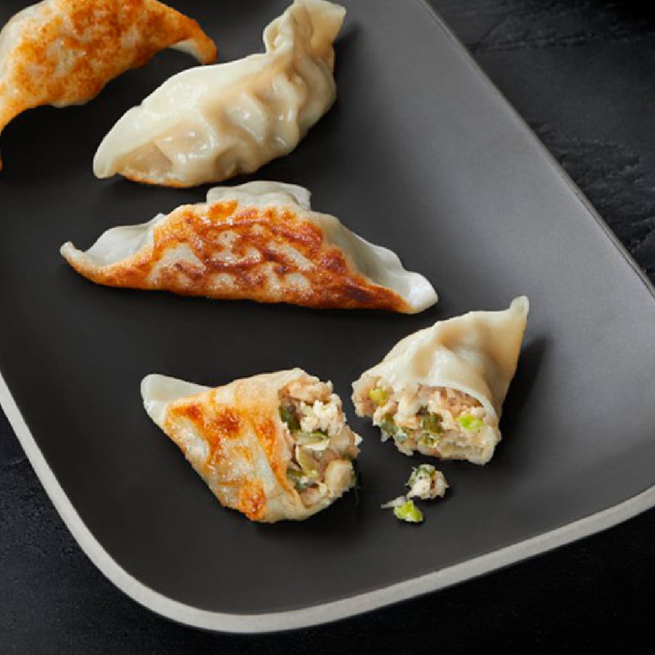 several dumplings on a serving tray