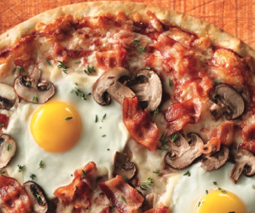 overhead photo of a pizza with an egg as a topping