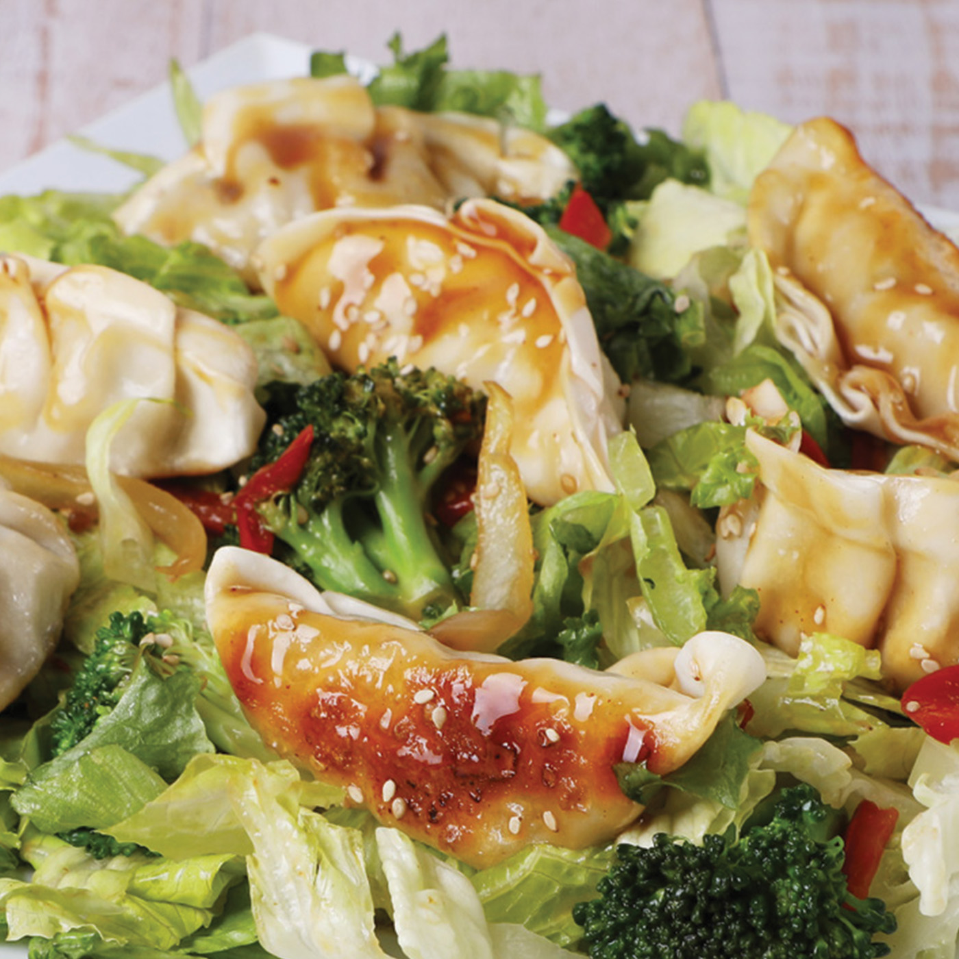 pan fried dumplings tossed in a salad with broccoli, lettuce and red peppers. 