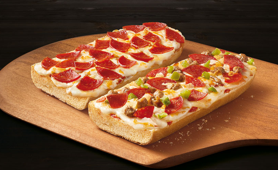 Two Red Baron french bread pizzas on top of a pizza peel